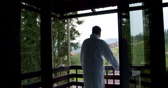 A Man in a White Coat Went Out on the Balcony.