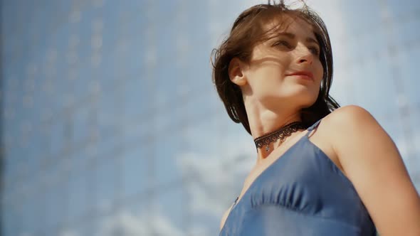 Model Posing In Front Of A Glass Skyscraper 