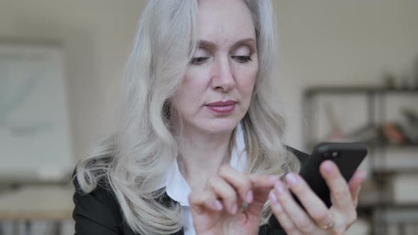 Old Businesswoman Using Smartphone