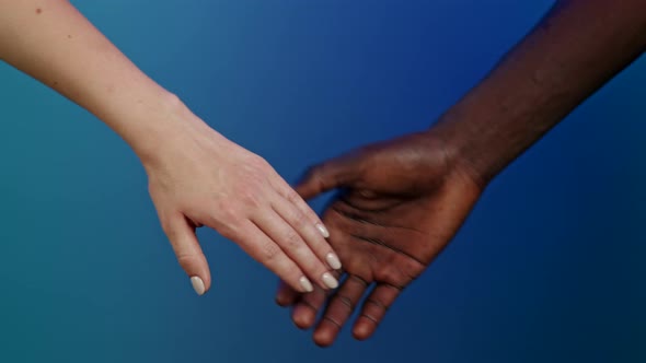 Hands of Black Man and White Woman Hold Each Other Together. Ethnic Diversity - Racial Equality
