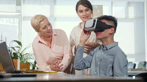 Colleagues Watching Young Businessman Using 3d Vr Glasses