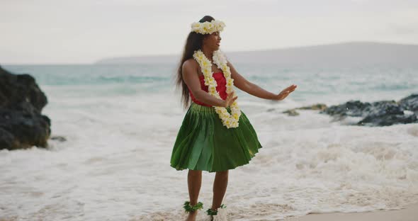 Woman performing Hawaiian hula on the beach