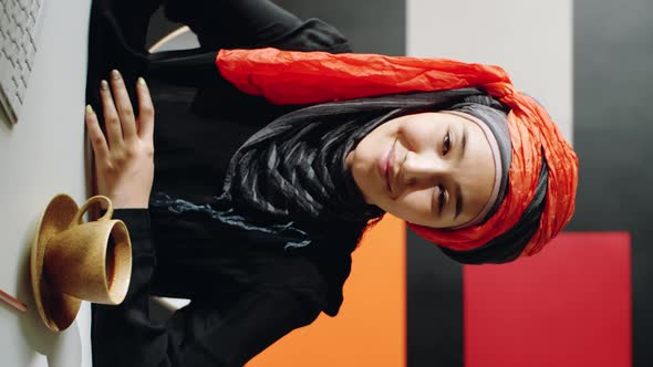 Young Muslim Woman Posing at Desk Vertical