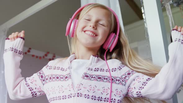 Happy girl dancing while listening music 4k