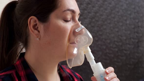 Closeup of Young Woman with Inhalation Mask on Her Face in Slow Motion