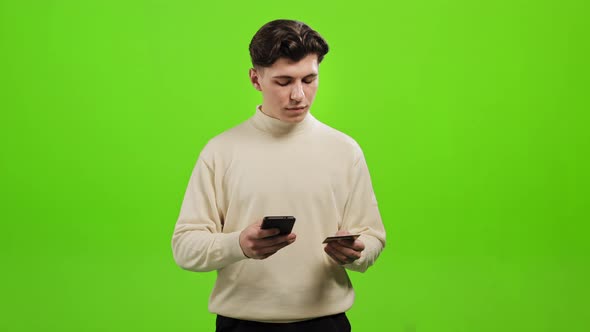 The Man is Entering His Bank Card Details Into His Smartphone