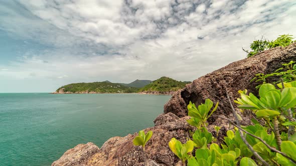 Tropical plants on a rocky coast in the background of the sea and islands Koh Phangan, Thailand