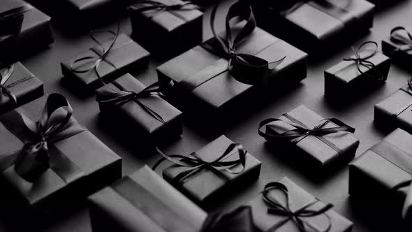 Elegant Black Christmas Theme. Wrapped Gifts in Black Matte Paper with Ribbon