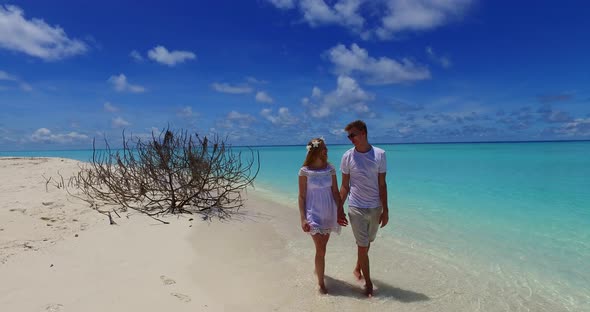 Fun lady and man in love dating on vacation spend quality time on beach on clean white sand background