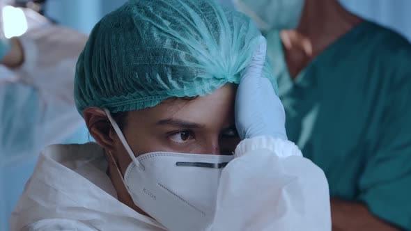 Female doctor putting on a medical cap, protective mask KN95, glasses and hazmat