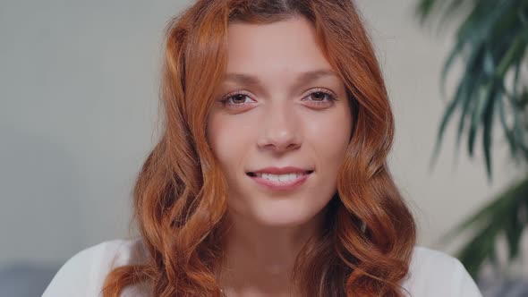 Portrait of Happy Ginger Woman with with Curly Hair Smiling Looking at Camera