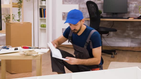 Confused Furniture Assembly Worker While Reading Instructions