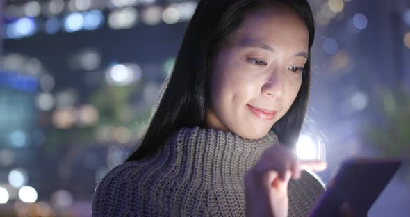 Woman Working on Smart Phone at Night