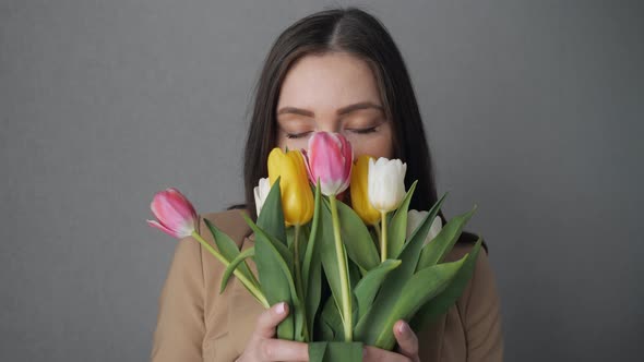 Young Girl Enjoy a Bouquet of Tulips