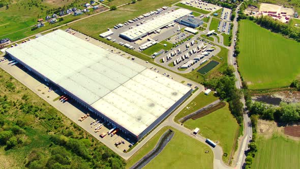 Aerial view of goods warehouse. Logistics center in industrial city zone from above. Aerial view of