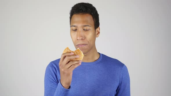 African Man Eating Burger White Background