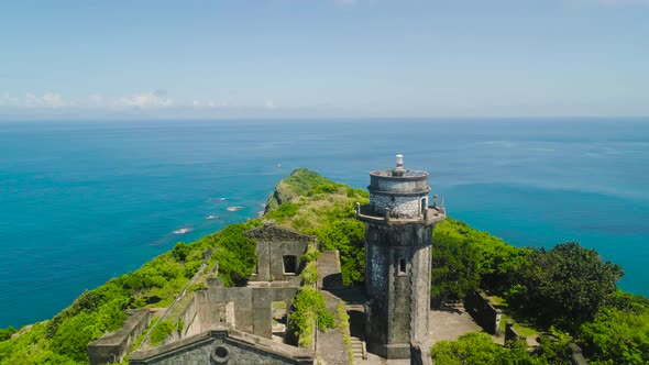 Lighthouse on a Hill By the Blue Sea