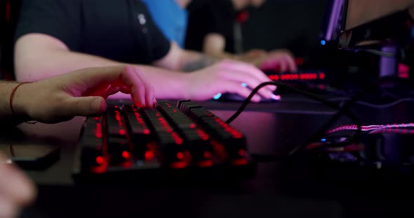 Close-up on the Hands of the Gamer Playing in the Video Game Using Keyboard Background with Cool