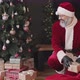 Santa Claus Putting Gifts under Christmas Tree - VideoHive Item for Sale