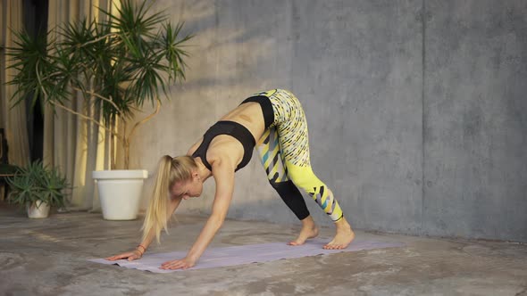 Female Coach Yoga Practicing Yoga in Loft Studio