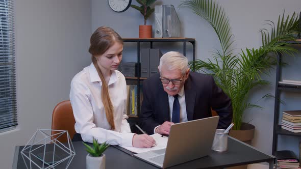 Senior Businessman Company Entrepreneur Ceo Examining Financial Data with Young Woman Secretary