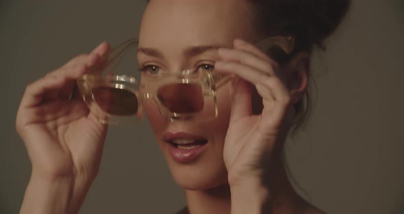 Beautiful Young Woman Trying On A Pair Of Sunglasses