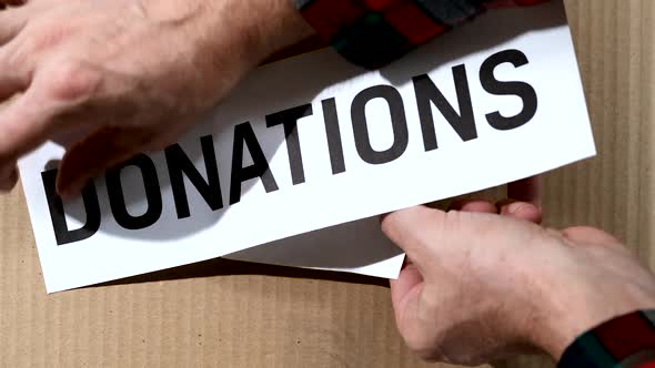 Volunteer sticks Donations  sticker on a Donation cardboard Box