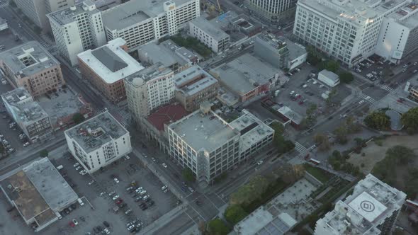 AERIAL Downtown Air View of Parking Lot in Los Angeles California Skyline at Beautiful Blue Sky and