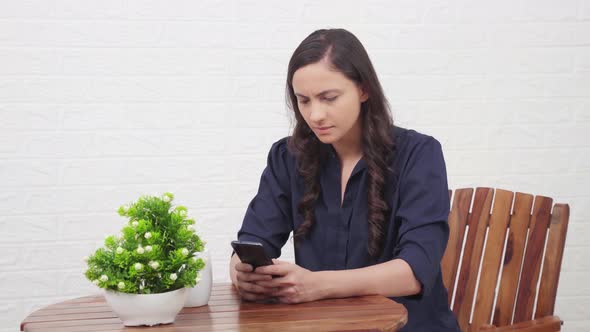 Angry Indian girl using phone