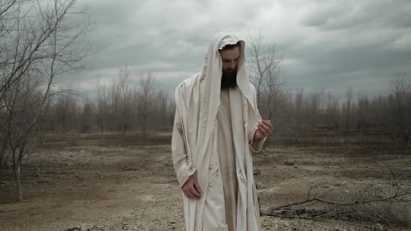 Jesus Drops Handful Of Dirt And Rocks In Slow Motion