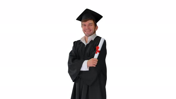 Male Student in Graduation Robe Posing with His Diploma Making Funny Faces on White Background