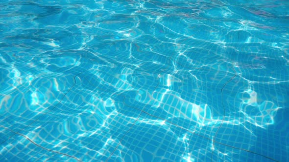 Blue Water in the Swimming Pool with Light Reflections