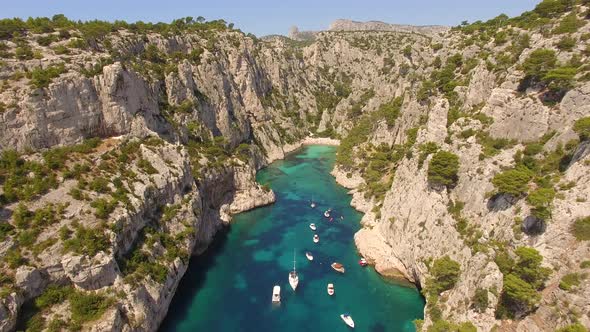 Aerial travel drone view of clear green water, cliffs of Cassis, Mediterranean Sea, Southern France.