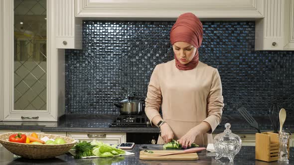 Housewife Prepares Dinner for Family Cutting Vegetables