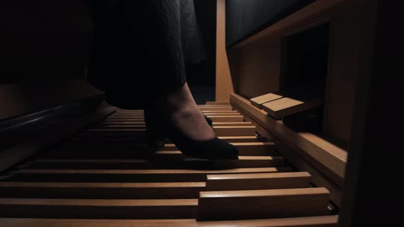 Young Woman Playing Electronic Organ with Her Feet