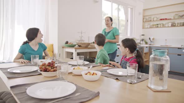 mother serving breakfast - a plate full of pancakes for her children