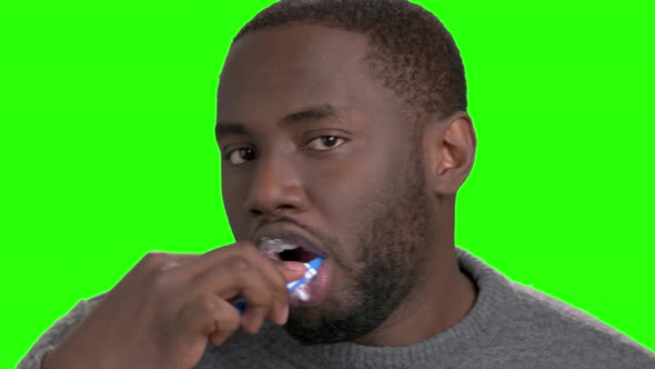 African American Man Brushing His Teeth.