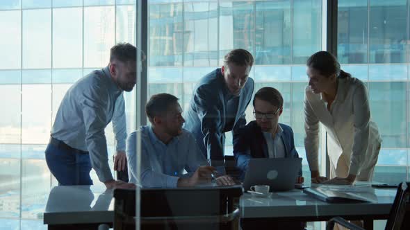 Middle age business people enjoying working together using laptop