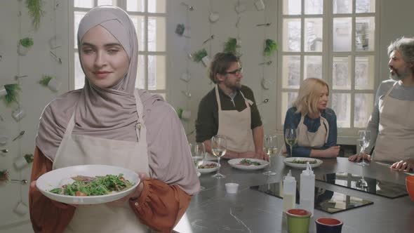 Young Muslim Woman With Dish At Cooking Class