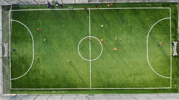 A Group of Children Playing Football on a New Field with Artificial Turf. The Player Scores a Goal