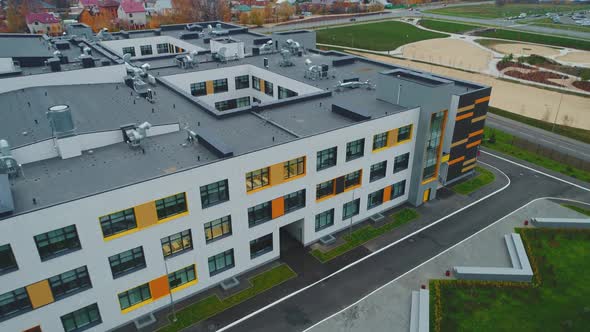 School Building with Flat Roof and Large Windows on Street