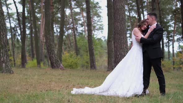 Beautiful Couple of Brides Walking in a City Park Wedding Day