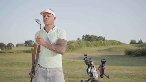 Portrait Confident Successful Middle Eastern Man with a Golf Club Standing on a Golf Course in Good