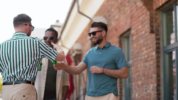 Happy Male Friends Drinking Beer at Rooftop Party