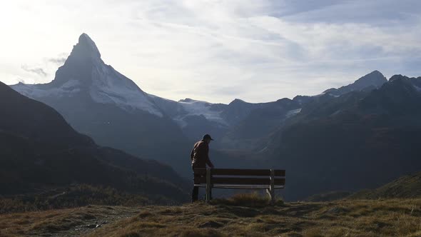 Picturesque View of Matterhorn Peak and Wooden Bench in Swiss Alps