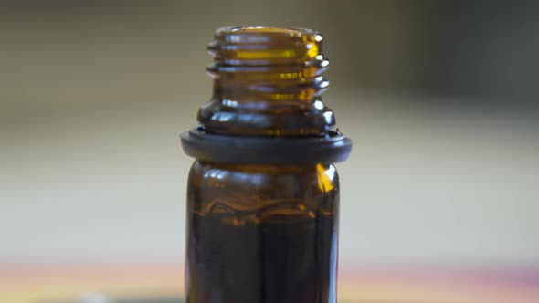 Droplets of Hemp Oil Going Into Glass Bottle. 