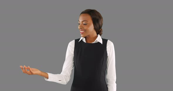 Businesswoman looking at something she holds in her hand