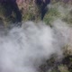 Drone view flying over a forest with clouds. Filming the deep forest from above with passing clouds. - VideoHive Item for Sale