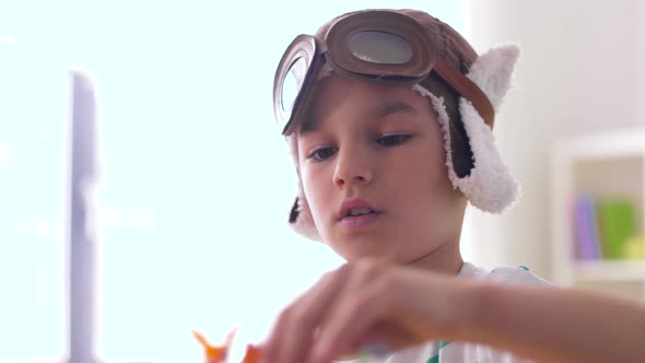 Boy in Pilot Hat Playing with Airplane Toy at Home 21