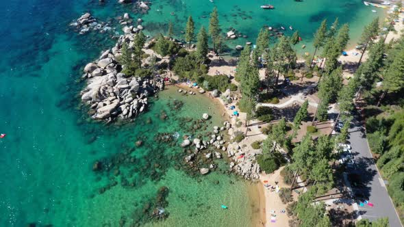 Crystal Clear Water With Rocky Shoreline And Pine Woods In Lake Tahoe, California, USA. Aerial Drone